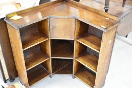 An early 20th Century oak corner low bookshelf having smokers cabinet to centre, approx. 69 x 69cm