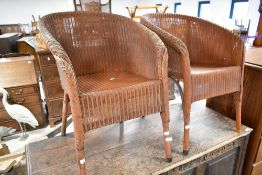 A pair of vintage Lloyd Loom tub chairs
