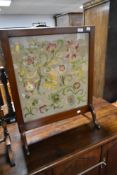 An early 20th Century mahogany framed embroidered fire screen