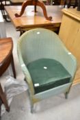 A vintage Lloyd Loom tub chair having upholstered seat