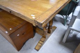 A traditional golden oak extending dining table, approx. 168 x 90cm