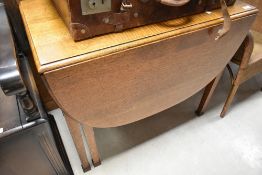 An early to mid 20th Century oak drop leaf table