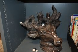 A 20th Century painted plaster bust of a stag, with some breakages and measuring 34cm high