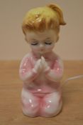 A vintage novelty night light styled as a little girl.