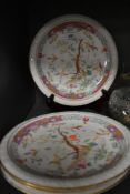Four oriental plates having florescent wildlife design to centre and gilding to rims.