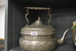 A Turkish embossed white metal flat-bottomed kettle, of traditional design with bands of embossed