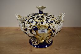 A late 19th/early 20th century pottery lidded tureen, with pierced cover, decorated throughout