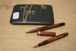 A Conway Stewart 526 Dinkie lever fill fountain pen and Dura point propelling pencil in red and
