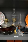 A vintage clear glass oil lamp having spotted glass base, a similar pressed glass oil lamp base,