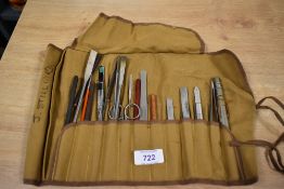 A canvas wrap containing a selection of tools possibly for art or crafting.