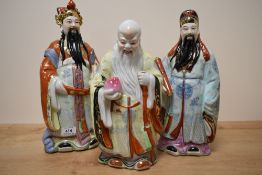 A group of three 20th century Chinese pottery immortals, each decorated in polychrome and