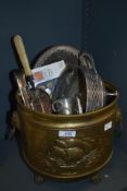 A large vintage brass effect jardiniere having lions heads ring handles to the sides, decorated with