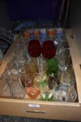 A selecti0on of assorted drinking glasses including advertising and water etc.