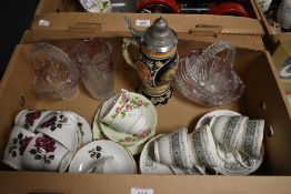 A collection of four matching glass display items including a vase and baskets, a musical beer stein