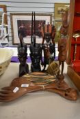 An African carved hardwood study of a warrior with weapons and shield, measuring 32cm high, together