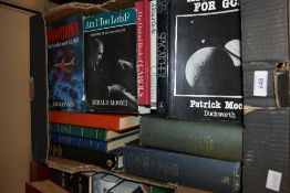 A selection of reading material, to include 'Astronomy for GCSE', 'Spycatcher', and 'Strange World