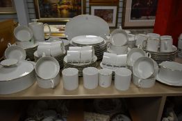 A large dinner service stamped 'Thomas Germany', white with gilt rim, to include tea pot, cups/
