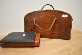 A mid-20th Century crocodile skin hand bag, measuring 38cm long, together with a tan leather