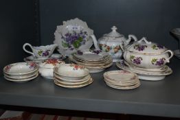 A vintage miniature tea set having violla's to white porcelain sold alongside other miniature