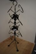 A modern free standing and wrought iron wine rack, having applied oak leaf and berry embellishments,
