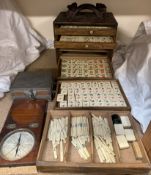 A Chinese Mah Jong set with five drawers of bone and bamboo counters in a carved cabinet together
