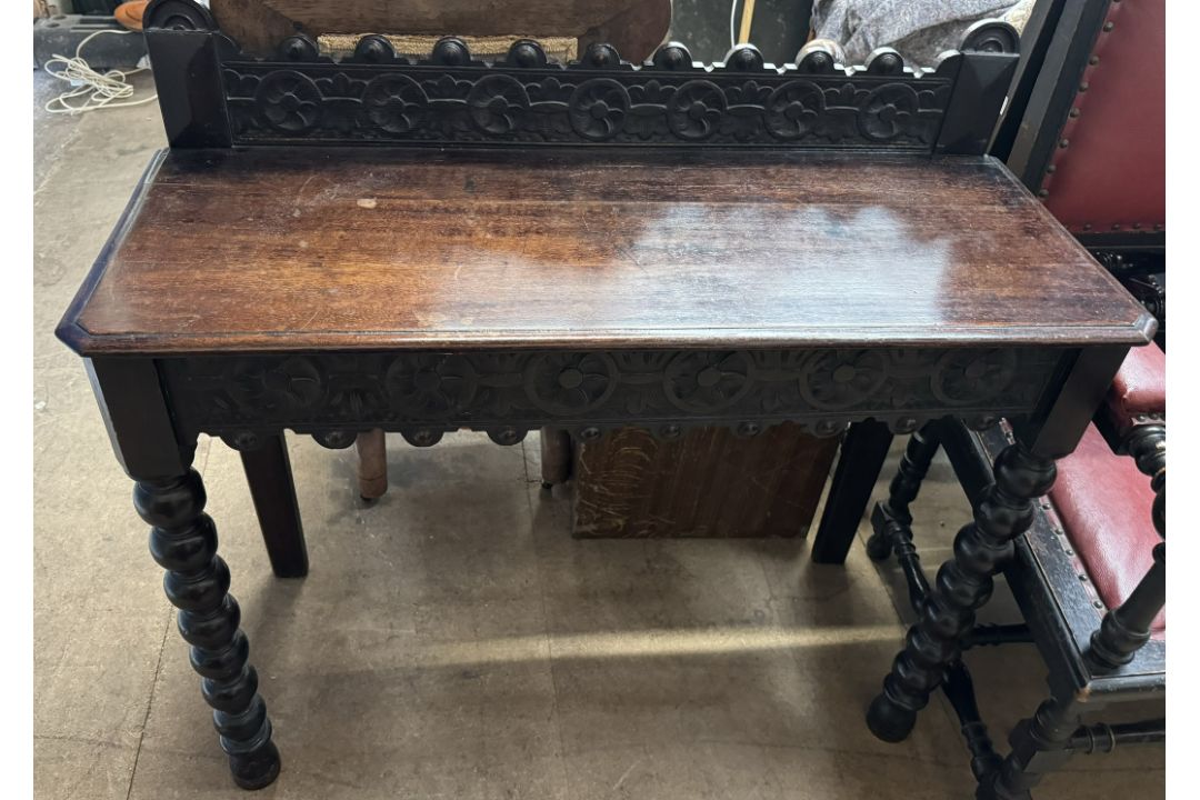 A 19th century oak side table with a carved rail,