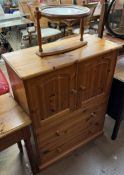 A pine linen cabinet with a rectangular top above two cupboards and two drawers together with an