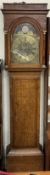 A 19th century oak long case clock with a caddy top and three quarter columns above a long trunk