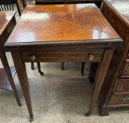 An Edwardian rosewood envelope card table, with a square folding top above a frieze drawer,