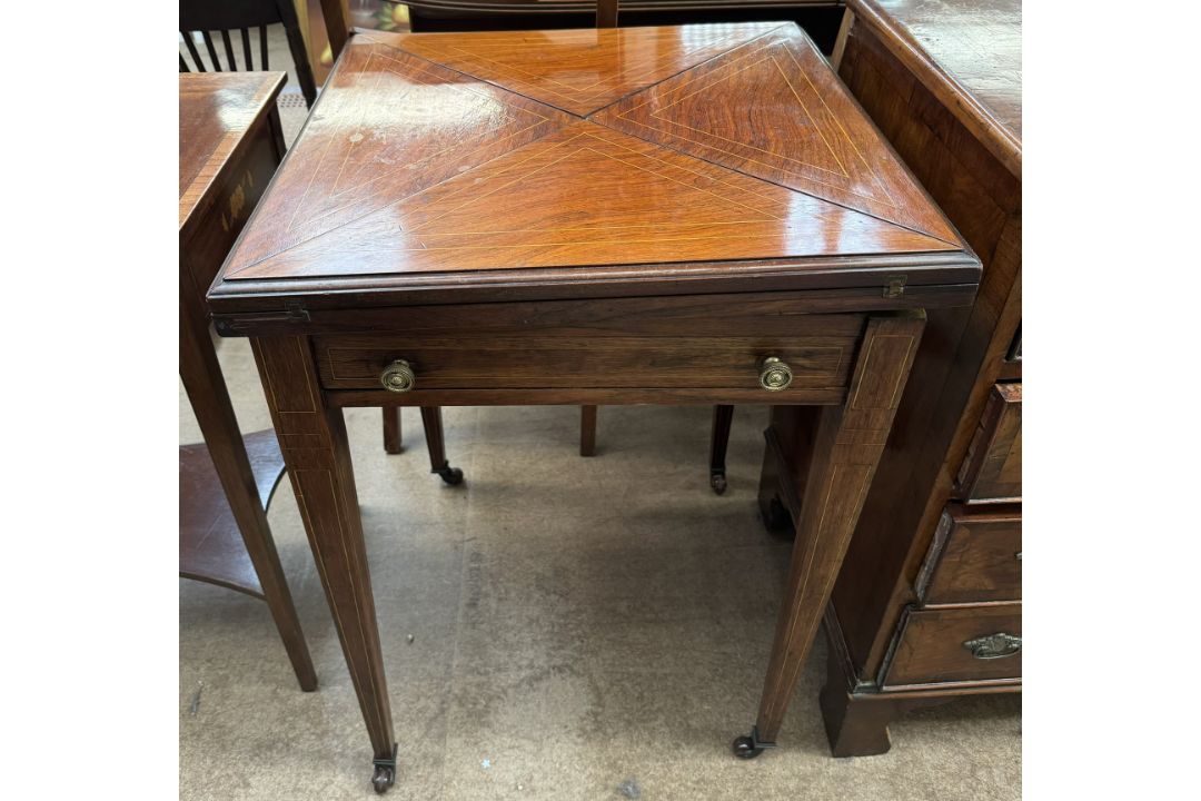 An Edwardian rosewood envelope card table, with a square folding top above a frieze drawer, - Image 1 of 2