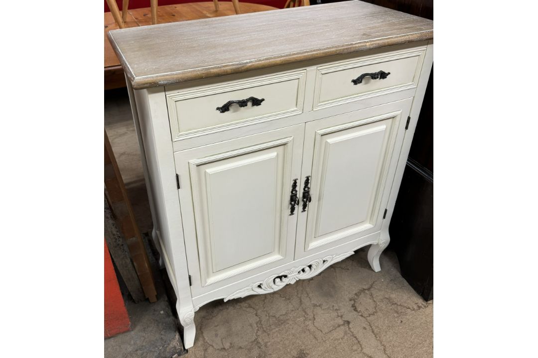 A cream painted side cabinet with a stripped top above two drawers and two cupboards on shaped legs