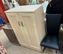 A lockable stationery cabinet together with another side cabinet and a dining chair