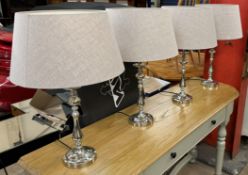 A set of four chrome table lamps