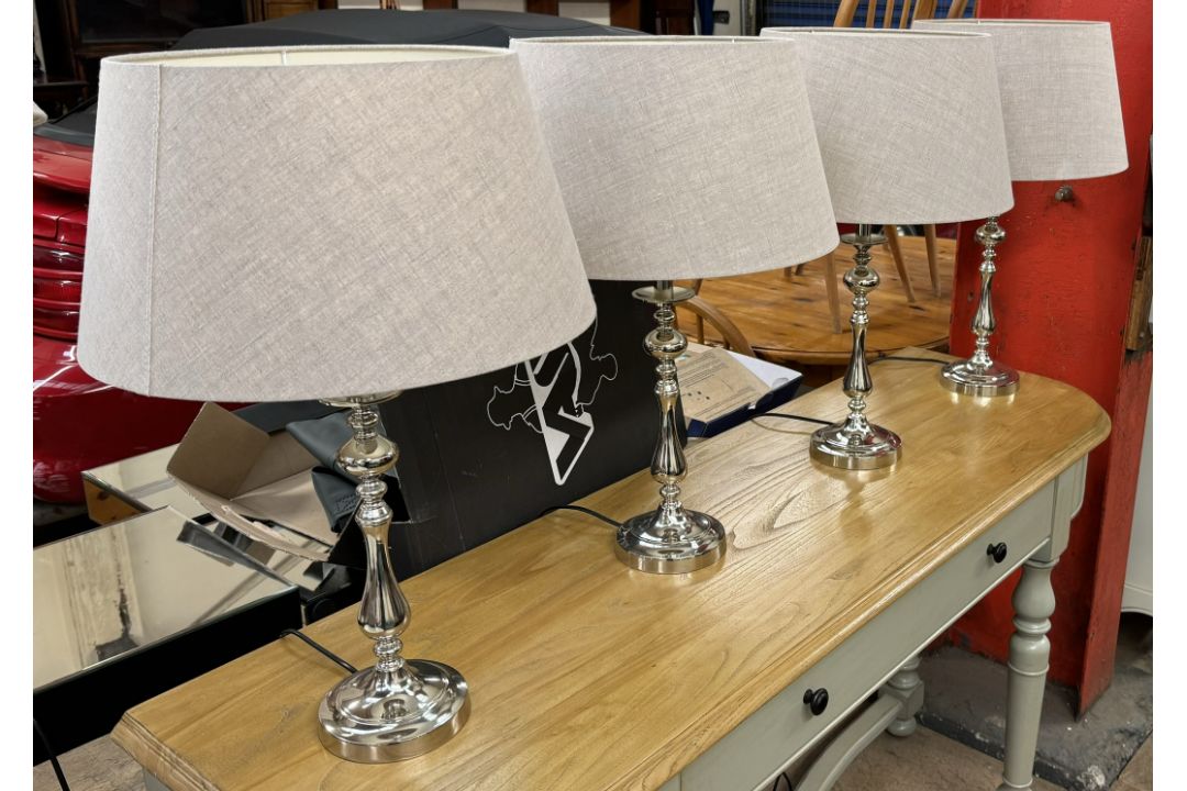 A set of four chrome table lamps