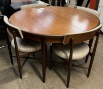 A G-Plan teak extending dining table and four chairs