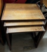 A mid-20th century teak nest of three tables,