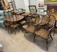A Regency style mahogany dining table and five chairs together with a pair of wheel back Windsor