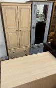 A modern wardrobe with matching chest of drawers together with a wardrobe with a mirrored door
