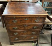 An 18th century style walnut chest with a rectangular crossbanded top above a brushing slide and