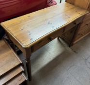 A 20th century pine side table with a rectangular top above two drawers on turned legs
