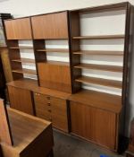 A mid 20th century teak G-Plan three section wall unit with cupboards,