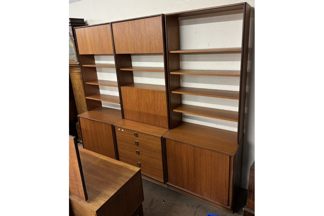A mid 20th century teak G-Plan three section wall unit with cupboards,