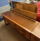 A mid-20th century teak dressing table, with a rectangular mirror and six drawers on shaped legs,