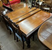 An Edwardian mahogany extending dining table on carved legs together with a set of four chairs