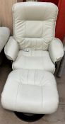 A cream leatherette reclining elbow chair and footstool