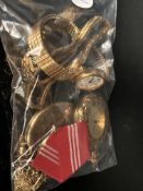 Bag of yellow metal items