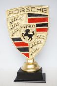 Metal gold Porsche sign on base Height 50 cm