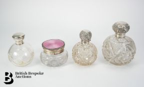 Four Large Silver Topped Scent Bottles