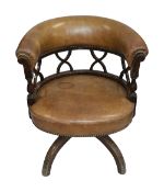 An Edwardian mahogany and leather tub shaped swivel desk chair