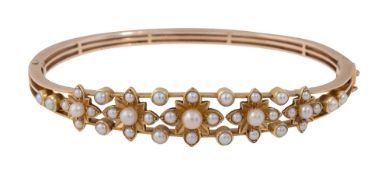 An Edwardian seed pearl hinge bangle